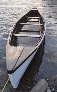 When the motor was removed from this Gander River Boat, the boat became leaky above her waterline. To reseal the seams, the owner filled the boat with water and left it overnight for the wood to plim.